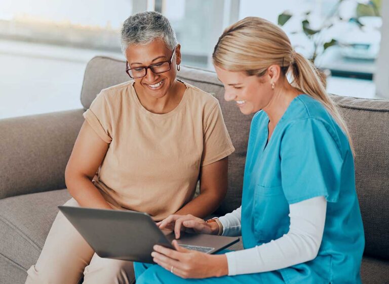 Family members review care authorization forms with an older adult at an assisted living table.